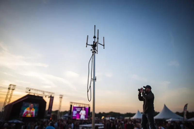 Starlink dish at a festival at dusk